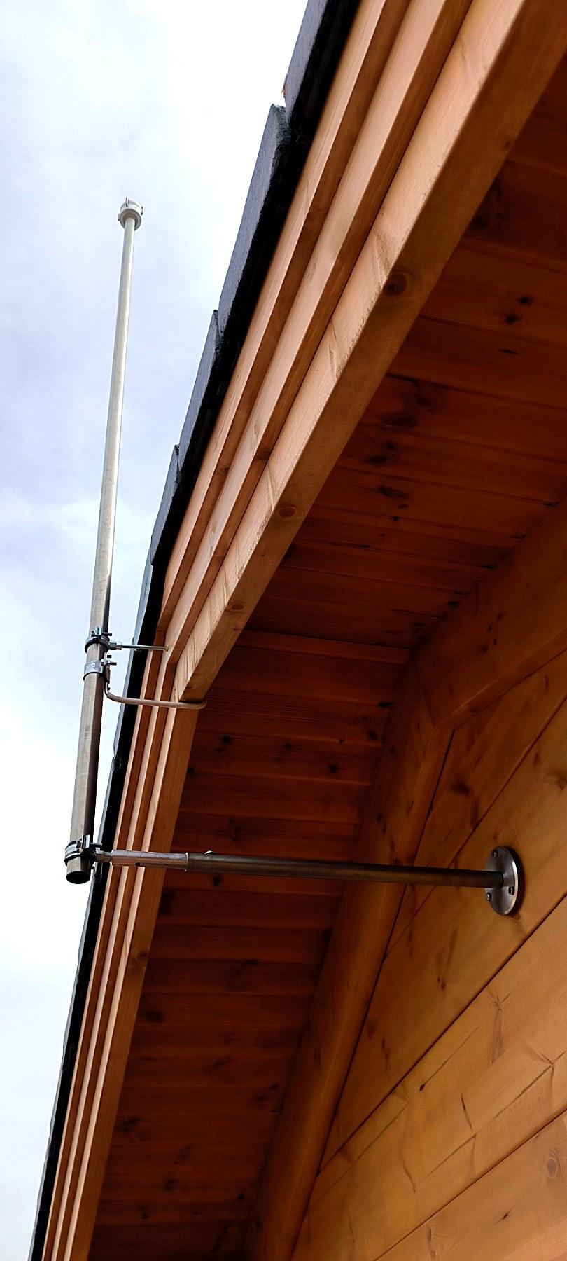 Installed lightning rod mast on a wooden roof edge